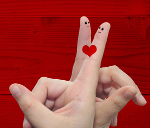 Conceptual love fingers on red wood