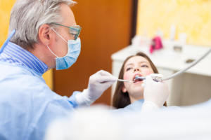 Dentist curing a female patient